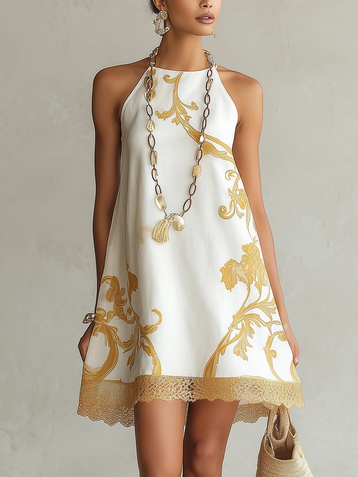 Minikleid aus weißer Spitze mit goldenen Motiven